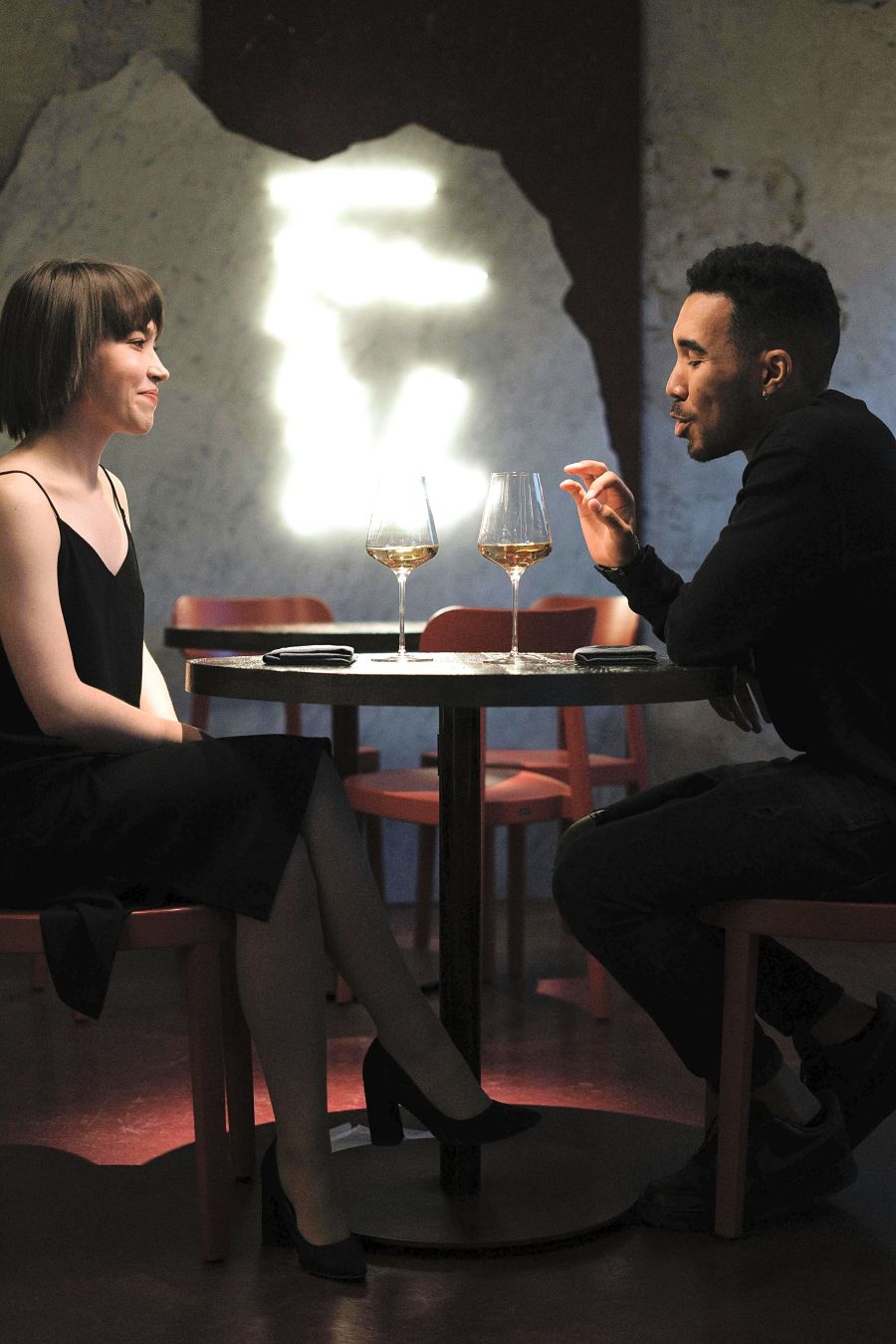 Man and Woman Sitting on Chair in Front of Table